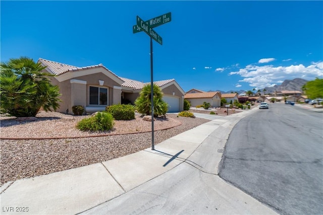 10301 Coal Creek Pl, Las Vegas, NV 89134 - view of front of property with a garage, stucco siding, a tile roof, and driveway