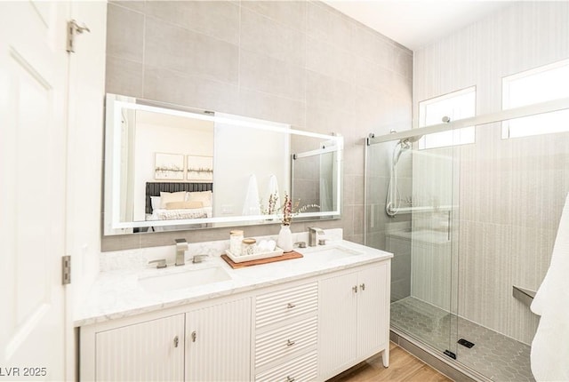 10301 Coal Creek Pl, Las Vegas, NV 89134 - full bathroom featuring double vanity, a shower stall, and wood finished floors