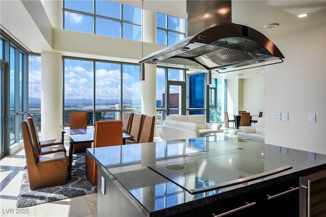 2700 S Las Vegas Blvd Unit 4305, Las Vegas, NV 89109 - kitchen with beverage cooler, island exhaust hood, black electric stovetop, and plenty of natural light