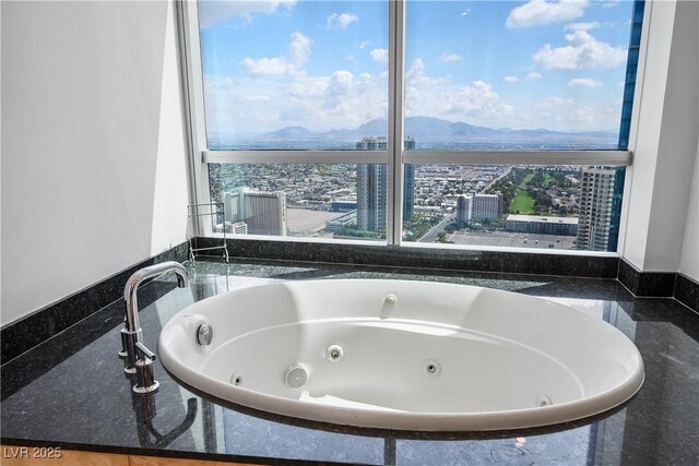 2700 S Las Vegas Blvd Unit 4305, Las Vegas, NV 89109 - bathroom with a mountain view, a tub with jets, a city view, and healthy amount of natural light