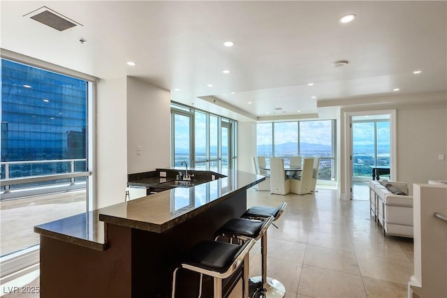 2700 S Las Vegas Blvd Unit 4305, Las Vegas, NV 89109 - kitchen featuring recessed lighting, a sink, open floor plan, light tile patterned flooring, and a tray ceiling