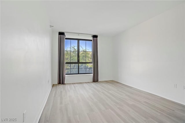 unfurnished room featuring light wood finished floors