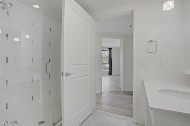 full bath with vanity, a shower stall, baseboards, and tile patterned flooring