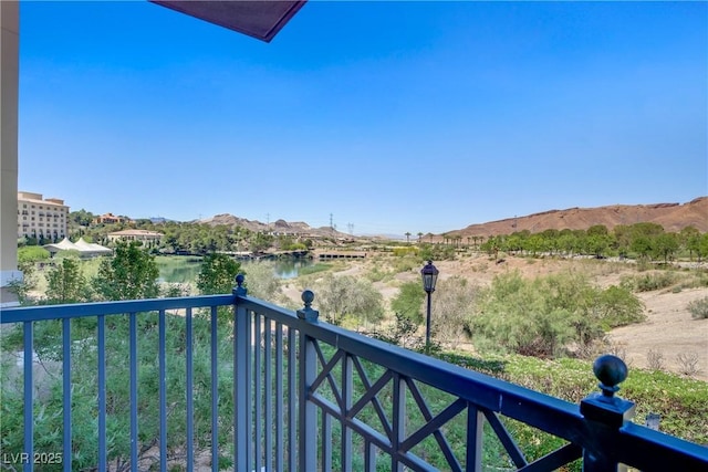 balcony featuring a water and mountain view