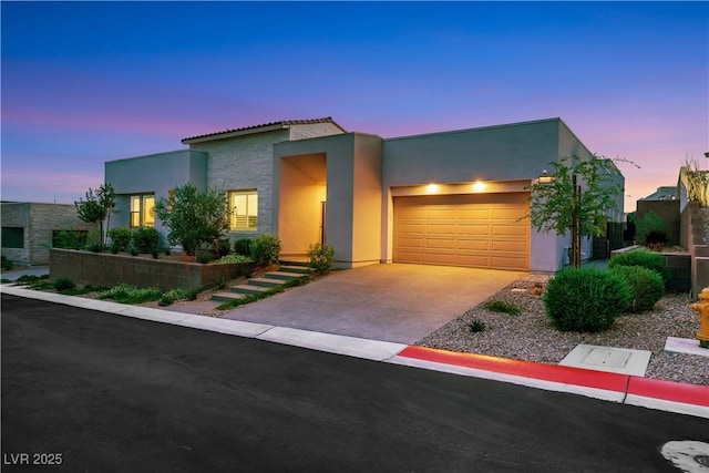 11895 Skyline Arch Ct, Las Vegas, NV 89138 - view of front of property featuring stucco siding, a garage, and driveway