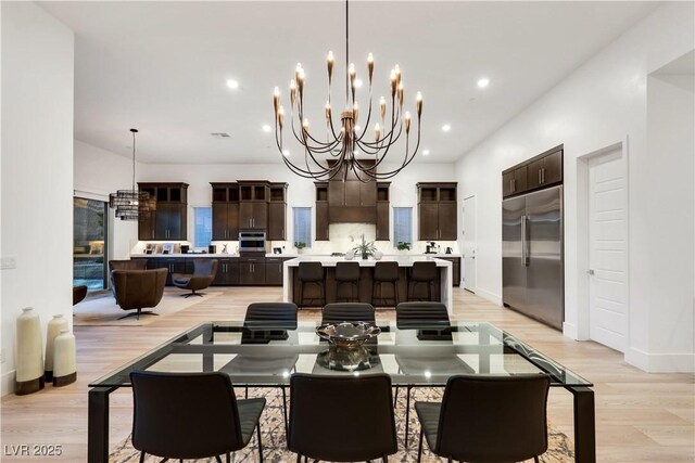 11895 Skyline Arch Ct, Las Vegas, NV 89138 - dining space featuring light wood finished floors, a chandelier, baseboards, and recessed lighting