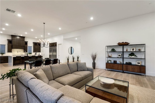 11895 Skyline Arch Ct, Las Vegas, NV 89138 - living area with a chandelier, light wood finished floors, recessed lighting, and baseboards