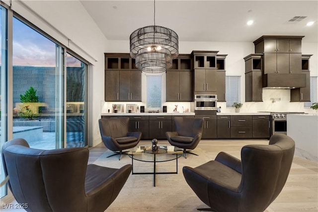 11895 Skyline Arch Ct, Las Vegas, NV 89138 - living area with a chandelier, light wood-style flooring, and recessed lighting