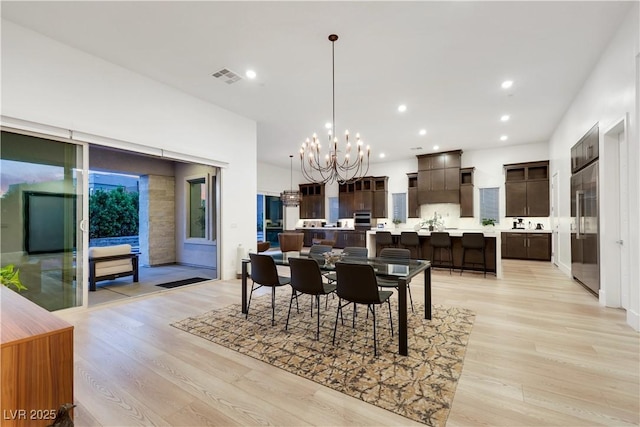 11895 Skyline Arch Ct, Las Vegas, NV 89138 - dining space featuring a chandelier, light wood finished floors, and recessed lighting