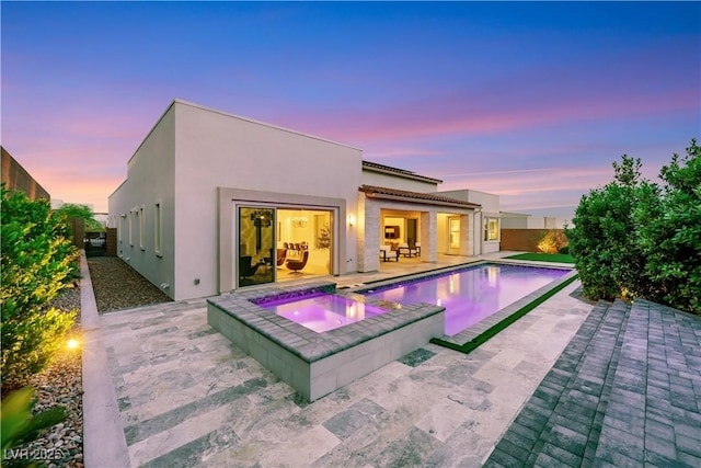 11895 Skyline Arch Ct, Las Vegas, NV 89138 - rear view of house featuring a patio, stucco siding, a fenced backyard, and a pool with connected hot tub