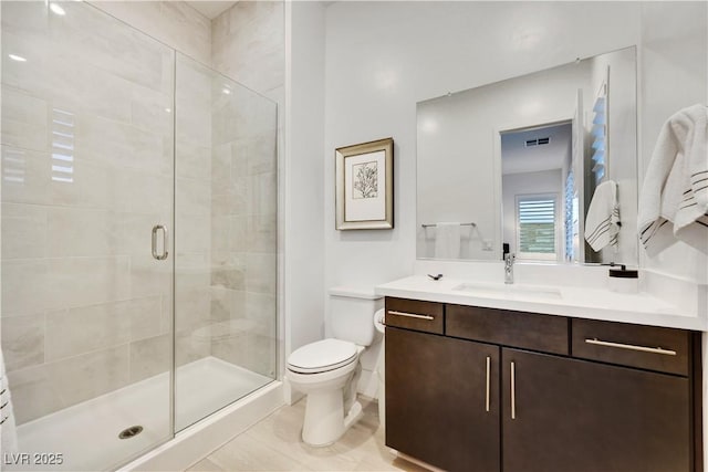11895 Skyline Arch Ct, Las Vegas, NV 89138 - bathroom featuring a shower stall, toilet, and vanity