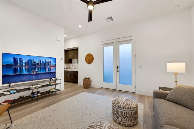 11895 Skyline Arch Ct, Las Vegas, NV 89138 - living room with light wood-style flooring, ceiling fan, baseboards, and recessed lighting