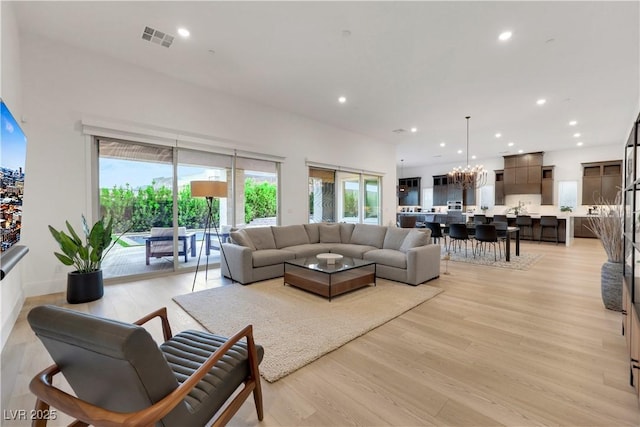 11895 Skyline Arch Ct, Las Vegas, NV 89138 - living room featuring light wood finished floors, recessed lighting, plenty of natural light, and a chandelier