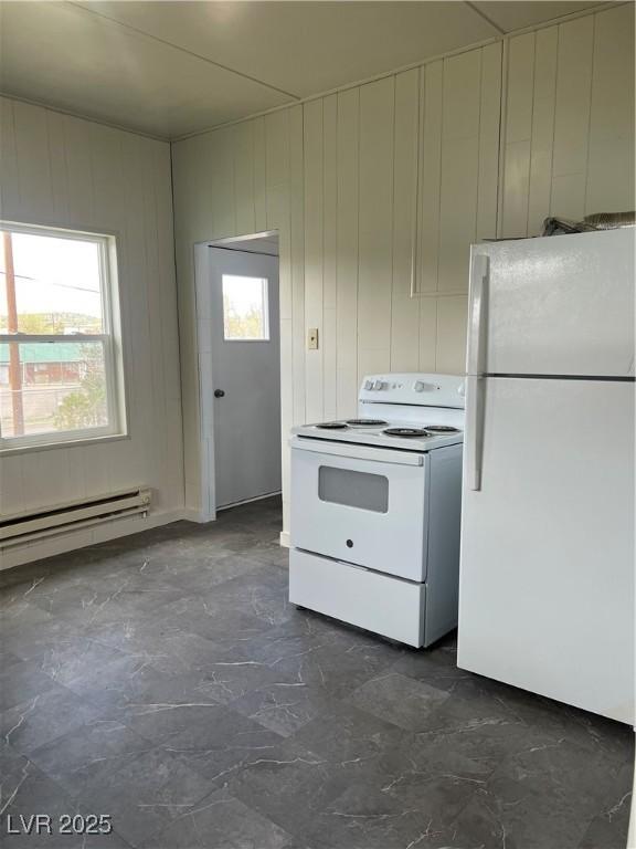 4 Keystone St, Ruth, NV 89319 - kitchen with white appliances, a baseboard heating unit, and wooden walls