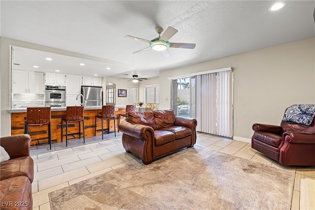 5449 Desert Spring Rd, Las Vegas, NV 89149 - living area with ceiling fan, recessed lighting, and a textured ceiling