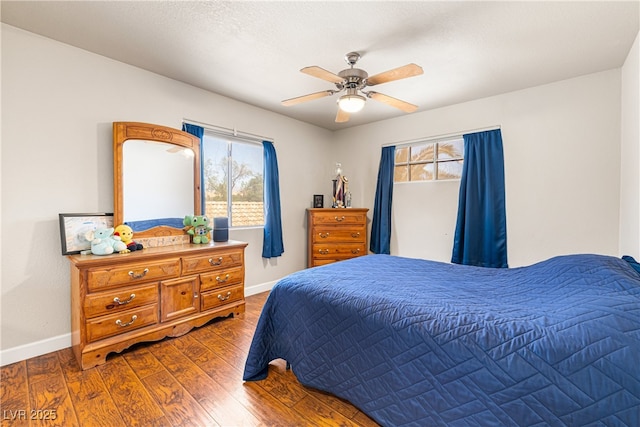 5449 Desert Spring Rd, Las Vegas, NV 89149 - bedroom with baseboards, wood finished floors, and a ceiling fan