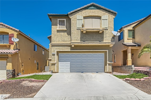 view of front of house with concrete driveway, an attached garage, stucco siding, and a tiled roof