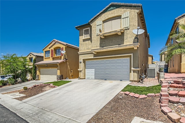 view of front facade featuring an attached garage, stucco siding, and concrete driveway