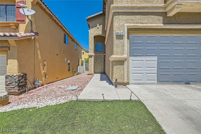 view of home's exterior featuring a garage, stucco siding, and a tiled roof