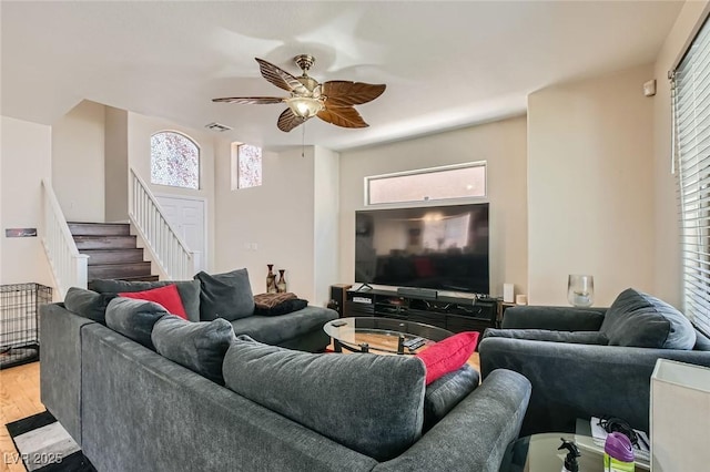living room with stairway, ceiling fan, and wood finished floors