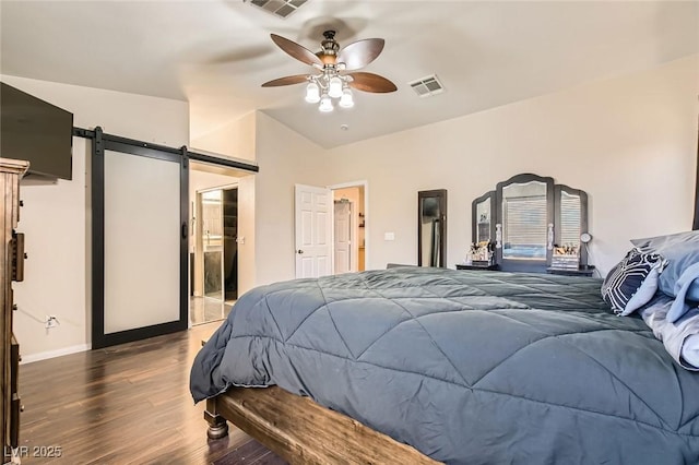 bedroom with a barn door, wood finished floors, baseboards, and a ceiling fan
