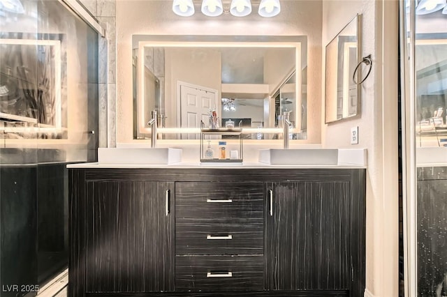 bathroom featuring a ceiling fan and double vanity