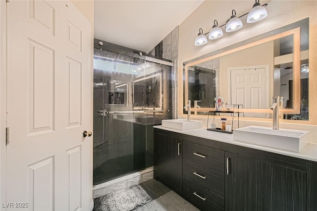 full bath featuring a stall shower and double vanity