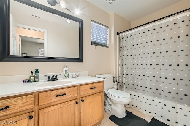 bathroom featuring tile patterned floors, vanity, toilet, and curtained shower