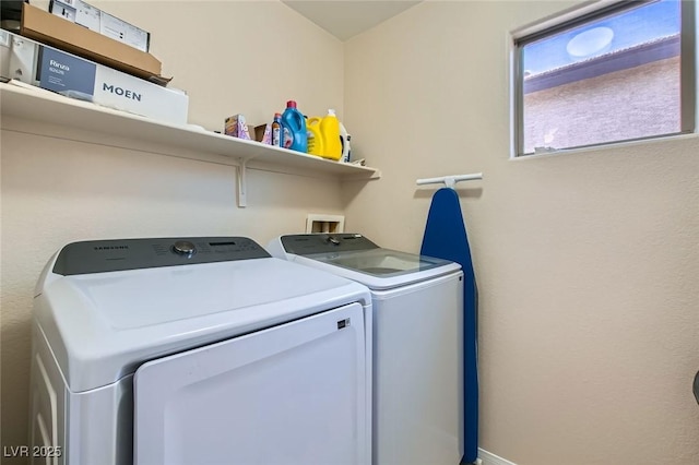 clothes washing area with washer and clothes dryer