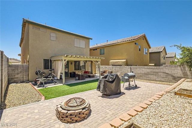 back of house with an outdoor living space with a fire pit, a pergola, a patio, a fenced backyard, and stucco siding