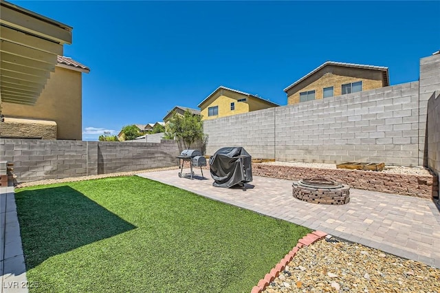 view of yard featuring a fire pit and a patio