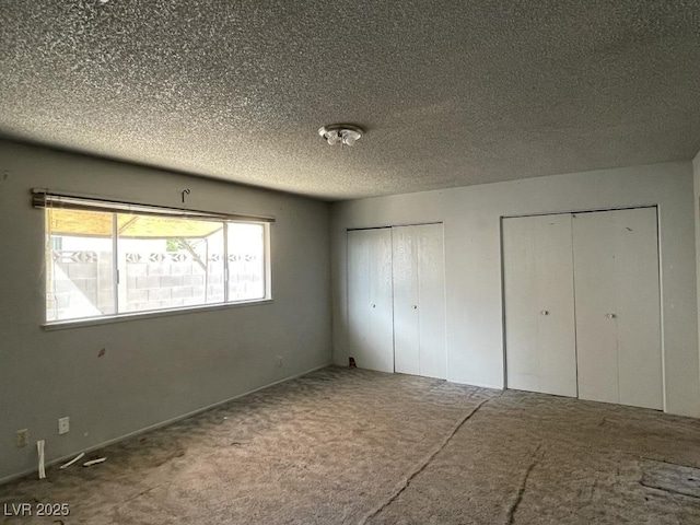 204 Bradshaw Way, Las Vegas, NV 89145 - unfurnished bedroom featuring two closets, a textured ceiling, and carpet