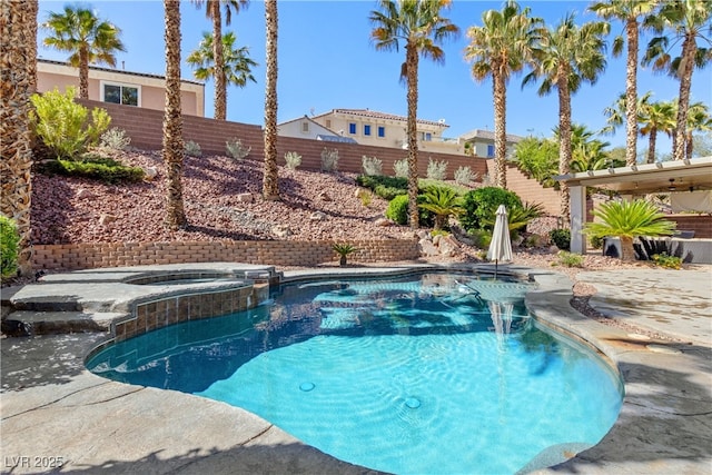 view of pool featuring a fenced backyard, a pool with connected hot tub, and a patio