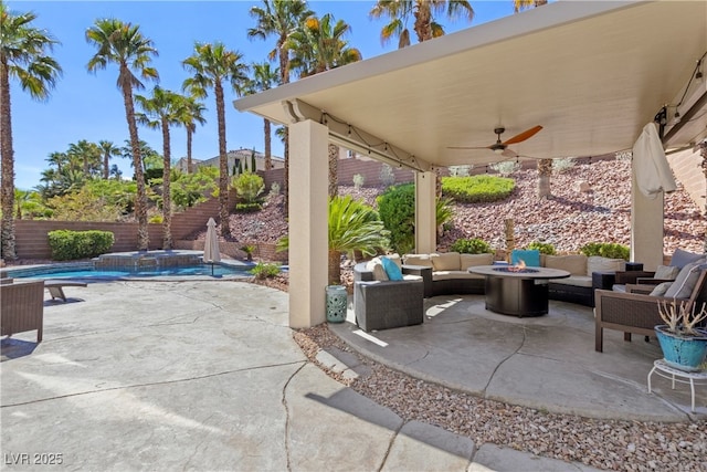 view of patio with an outdoor living space with a fire pit, ceiling fan, a fenced backyard, and a pool with connected hot tub