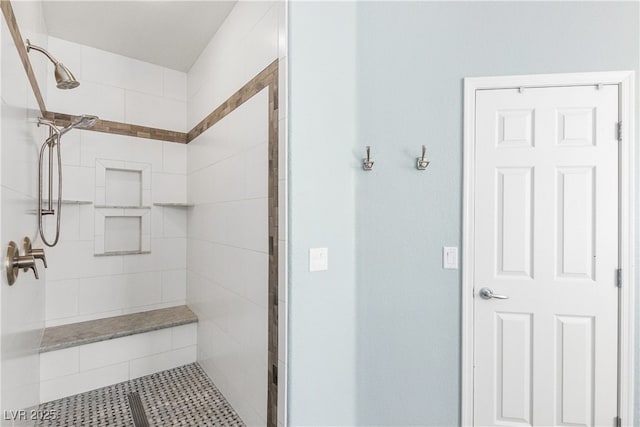 bathroom with a tile shower