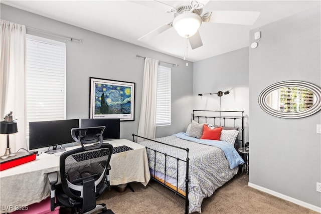 bedroom featuring carpet floors, an office area, baseboards, and a ceiling fan