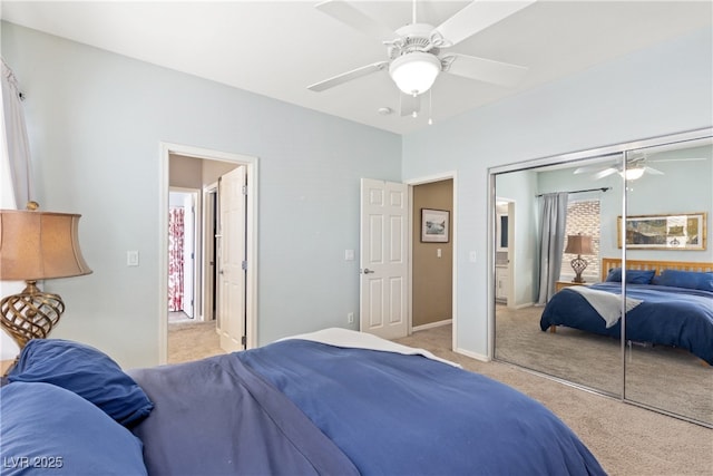 bedroom with carpet flooring, ceiling fan, a closet, and baseboards
