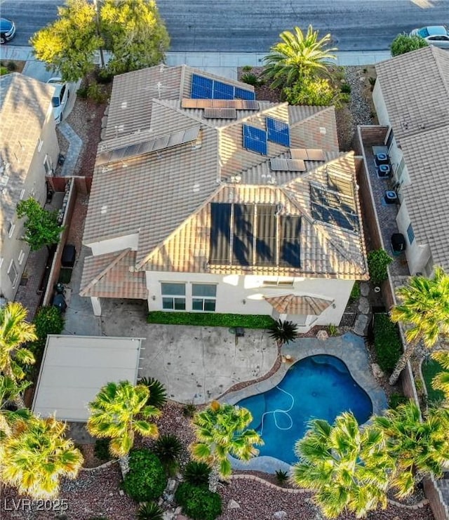 aerial view of property and surrounding area featuring a pool area