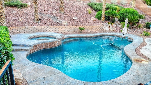 view of pool featuring a pool with connected hot tub
