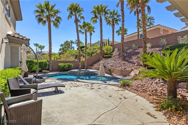 view of pool with a fenced backyard, a patio, and a pool with connected hot tub