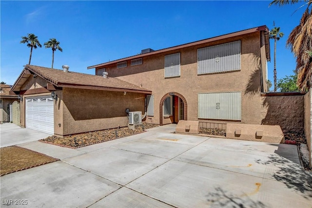 4990 Spring Oak St, Las Vegas, NV 89120 - view of front facade with ac unit, stucco siding, a garage, and driveway