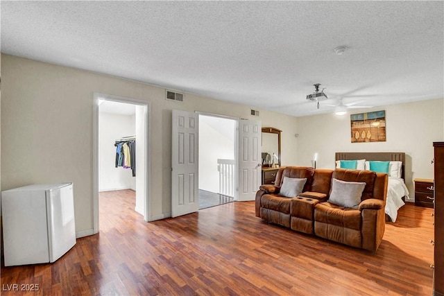 4990 Spring Oak St, Las Vegas, NV 89120 - living room with wood finished floors, a ceiling fan, and a textured ceiling