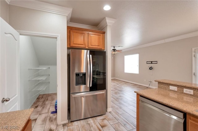 8152 Satin Carnation Ln, Las Vegas, NV 89166 - kitchen featuring stainless steel appliances, ornamental molding, light wood finished floors, a ceiling fan, and baseboards
