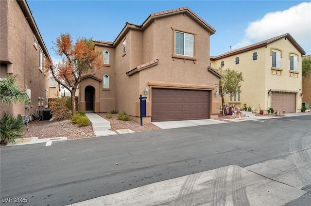 8152 Satin Carnation Ln, Las Vegas, NV 89166 - view of front of home with an attached garage, stucco siding, a tile roof, and central AC unit