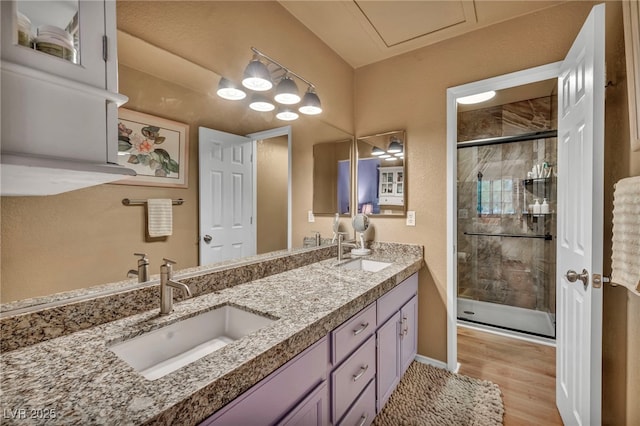 2725 S Nellis Blvd Unit 2052, Las Vegas, NV 89121 - full bath featuring a shower stall, double vanity, wood finished floors, and baseboards