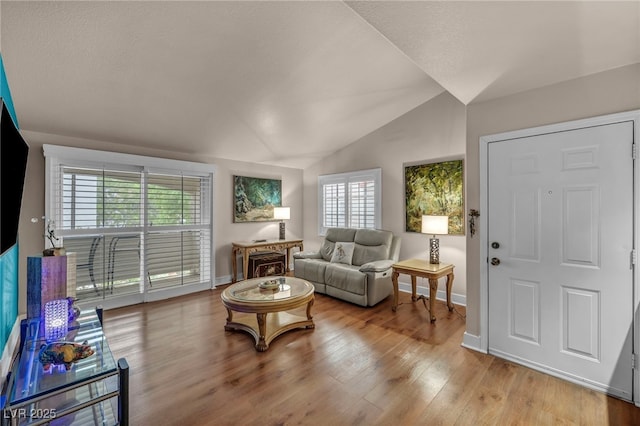 2725 S Nellis Blvd Unit 2052, Las Vegas, NV 89121 - living room featuring lofted ceiling, wood finished floors, and baseboards