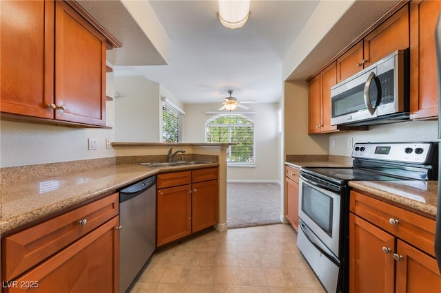 4400 S Jones Blvd Unit 2033, Las Vegas, NV 89103 - kitchen with appliances with stainless steel finishes, a sink, a peninsula, ceiling fan, and light carpet