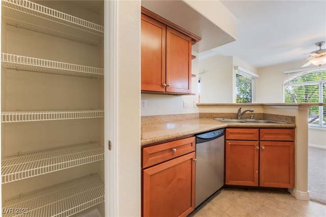 4400 S Jones Blvd Unit 2033, Las Vegas, NV 89103 - kitchen with stainless steel dishwasher, a sink, a peninsula, light tile patterned floors, and ceiling fan