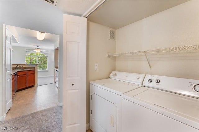4400 S Jones Blvd Unit 2033, Las Vegas, NV 89103 - washroom with washer and clothes dryer, light colored carpet, a ceiling fan, and baseboards
