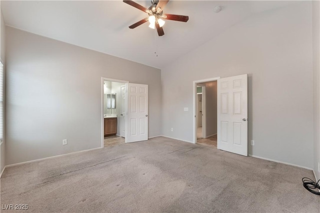 unfurnished bedroom featuring light carpet, baseboards, and high vaulted ceiling